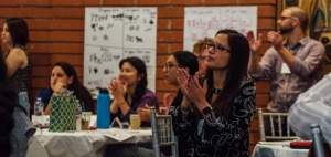 Workshop participants clapping and smiling