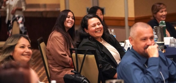 Photo of smiling and engaged audience at a workshop