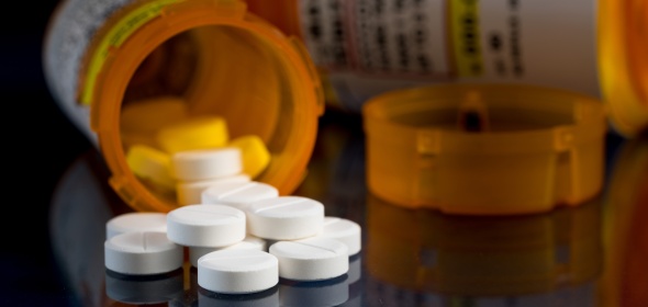 Photo of pills and pharmaceutical bottle.