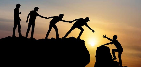 People help each other up a mountain