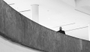 Photo of lone person standing at a wall