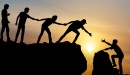 People help each other up a mountain